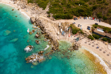 Fototapeta na wymiar Aerial photo of fishing boats by rocks at paradise exotic sea of Petani beach under the mountain at Kefalonia island Greece