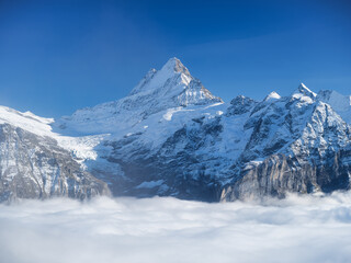 Fototapeta premium Mountains peaks and clouds in the valley. Natural landscape. Mountain range through the clouds. Landscape in the summertime. Large resolution photo.