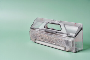 Transparent dust container of the robot vacuum cleaner after cleaning the house, completely clogged...