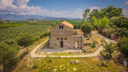 Fototapeta na wymiar Aerial drone photo of ancient Vyzantine church of Agios Ioannis Riganas on top of hill at West Greece