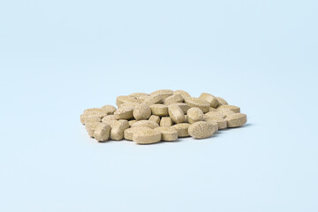 Daily vitamins on a light background. Light brown pills