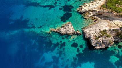 Naklejka na ściany i meble Aerial photo of rocks and sea bed at tranquil paradise turquoise water in Ithaca Greece