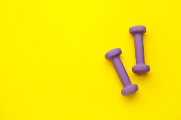 Purple dumbbells on yellow background