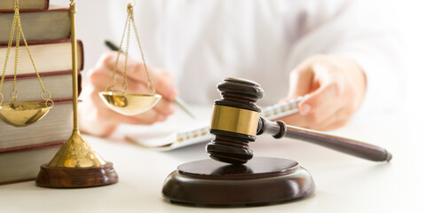 Lawyer working with contract papers and wooden gavel on tabel in courtroom. justice and law ,attorney, court judge concept.