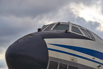 Part of the old vintage plane under the cloudy sky, forgotten aircraft 