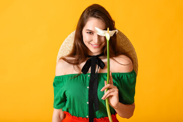 Beautiful young woman with calla flower on color background
