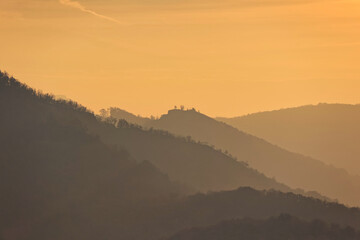 sunrise over mountains rolling landscape with autumn fog over the river