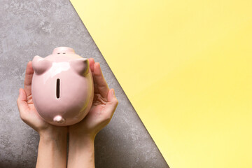 woman hand putting money coin into piggy for saving money wealth and financial concept - 466354092