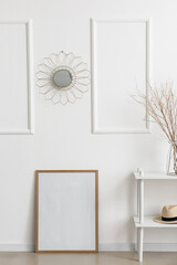 Blank poster frame near stylish wall
