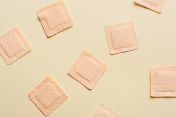 Adhesive plasters on color background, closeup