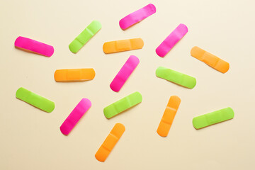 Different medical plasters on color background