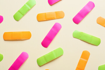 Different medical plasters on color background, closeup