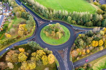 Aerial view of a small traffic roundabout in a Welsh town during the autumn