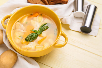 Bowl with delicious dumpling soup on color wooden background, closeup