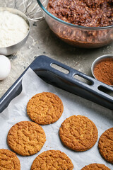 Baking dish with tasty hojicha cookies and ingredients on grunge background, closeup
