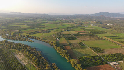 Aerial view of trees and farmland next to Acheloos river in West Greece