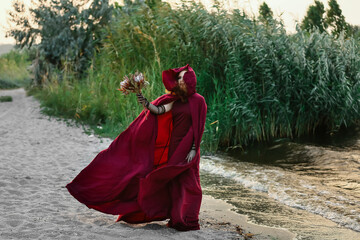 Portrait of beautiful young witch outdoors