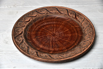 Empty plate for food on white wooden table