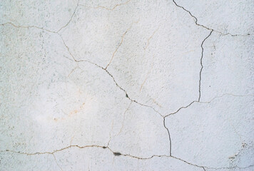 Cracked, grungy white wall. Texture close up.