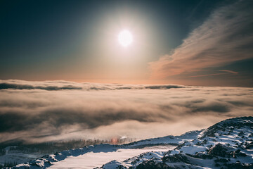 Dawn on a mountain under the clouds in the north in winter 