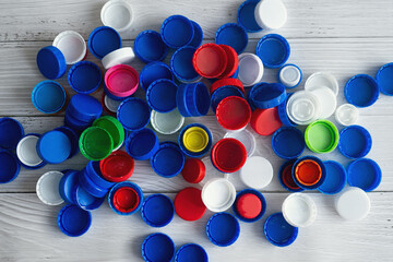 Sorting household colored plastic bottle caps and lids captured from above, flat lay. Zero waste and eco friendly deliberate sorting of garbage 