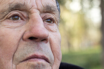 Brown eyed senior man looking away