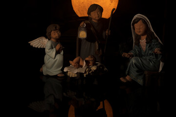 christmas scenary of the born of jesus christ with mary and joseph an angel and the moon in the...