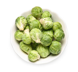 Raw Brussels cabbage in bowl on white background