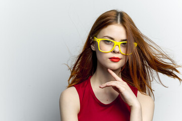 pretty woman yellow glasses and red lips fashion light background