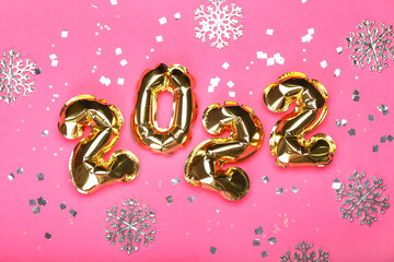 Balloons in shape of figure 2022 on color background