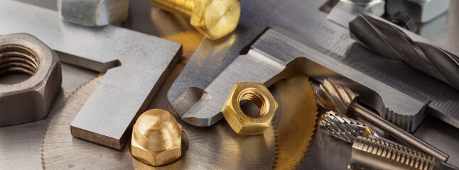 nuts, bolts, screws, washers, bearings on a metal steel background.