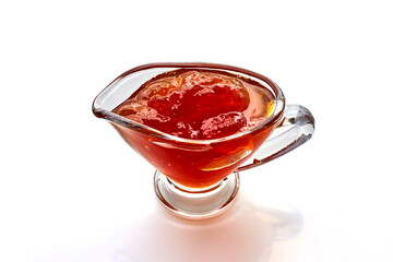 Fruit jam in glass bowl isolated on white background.