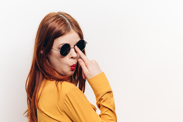 fashionable woman in yellow shirt sunglasses posing