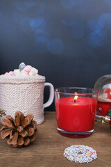 warm colored sweaters, a cup of hot cocoa with marshmallows, candles, gifts, sweets, the concept of merry christmas, cozy winter mood, holiday