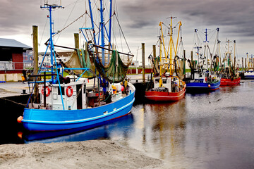 fish trawlers in a fish port at low tide