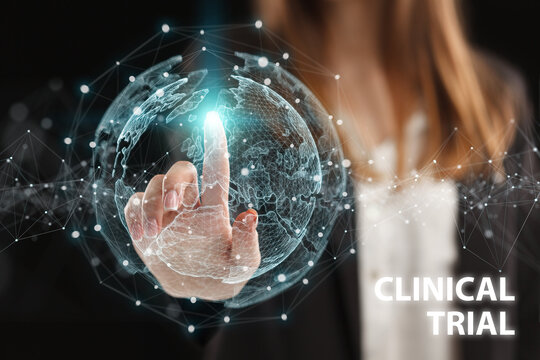 Business, Technology, Internet and network concept. Young businessman working on a virtual screen of the future and sees the inscription: Clinical trial