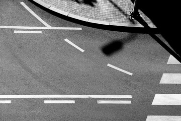 Shadows and road markings on city street in black and white