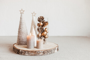Christmas table decoration with candles and handmade minimalist christmas trees. Festive interior...