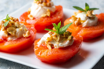 Traditional Turkish style quince dessert. The quince is cooked until soft, sherbet is poured on it, and served with cream and walnuts. It is one of the most popular Turkish desserts.(Ayva Tatlisi)