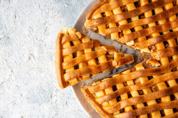 Homemade Apple Pies on a white wooden background, top view. The classic fall Thanksgiving dessert - organic apple pie.