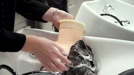 students wash the hair of mannequins at a hairdressing course