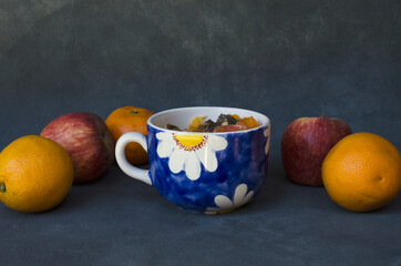 bowl of fruit salad, with oranges and apples around