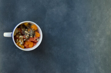 fruit salad breakfast, on blue-gray tablecloth with copyspace to fill