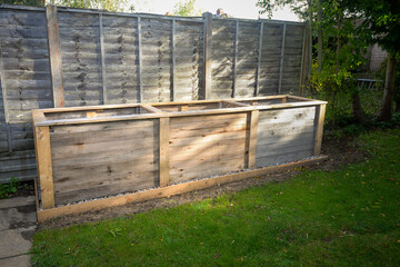 Empty timber tall deep root vegetable box planter ready for filling with compost and planting.