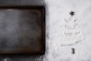 Baking Concept. Top view of a baking sheet on a counter top covered with flour in a Christmas Tree...