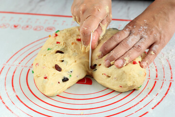 Female Hand Divided Bread Dough of Christmas Stollen into Smaller Pieces, Step by Step Baking in...