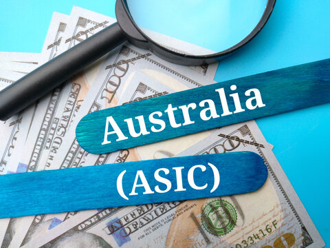 Banknotes,magnifying glass and colored ice cream sticks written with text Australia (ASIC) . Trading concept. - Powered by Adobe