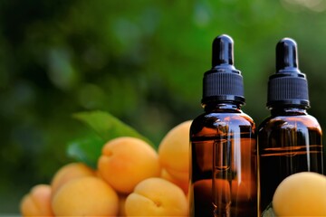 Apricot kernel oil. Organic natural oil. Apricot oil in a glass bottle with a pipette and ripe apricots fruits. natural Apricot oil