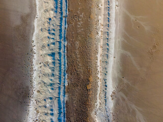 Aerial view of a dried-up riverbed as a result of global climate change. Dry river bed with top...