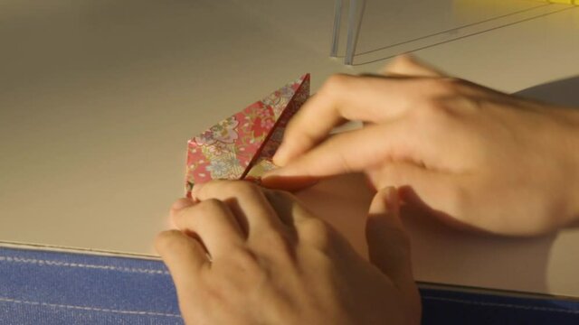 Woman prepares origami in Japan.